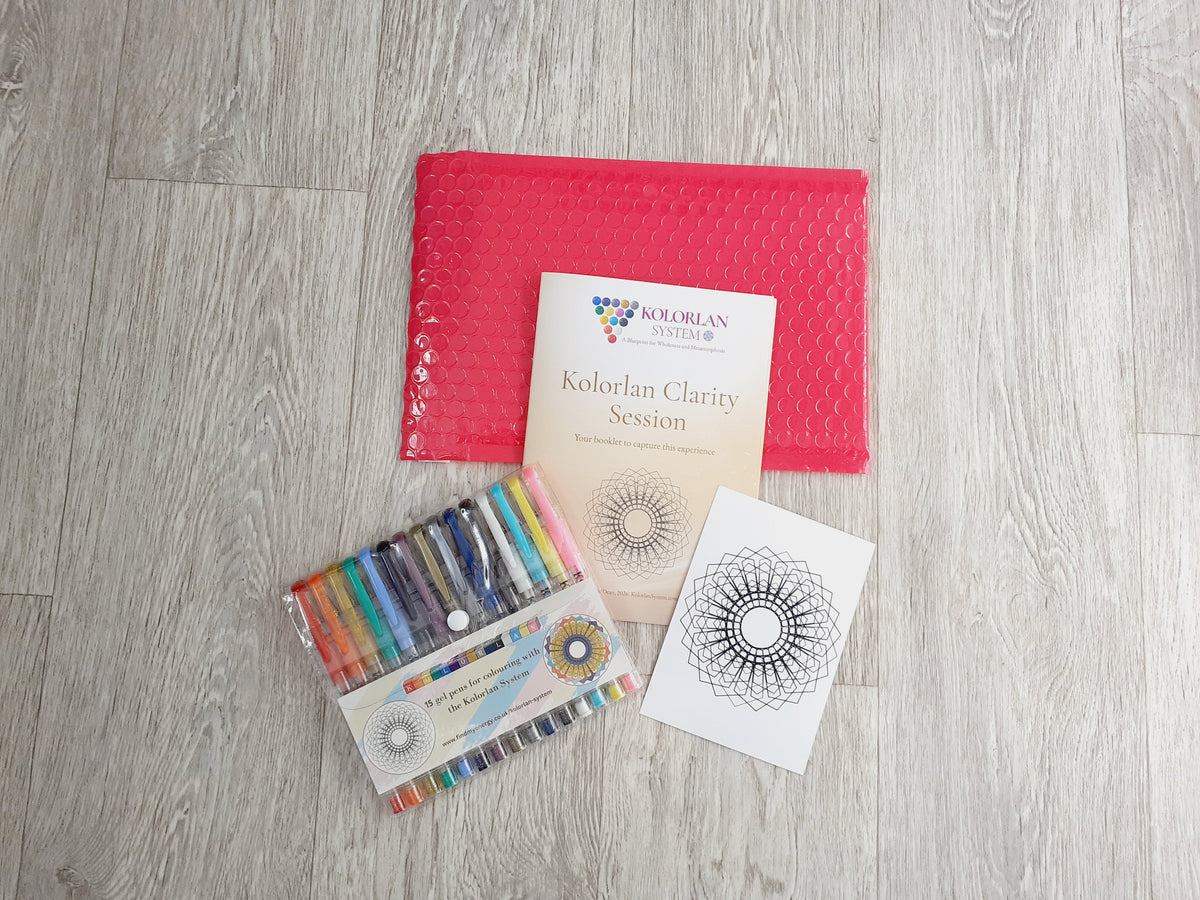 Kolorlan Clarity Session kit laid out on a light wood floor, including a magenta bubble mailer envelope, a 20-page booklet, a special Kolorlan geometry card for colouring, and a set of the unique Kolorlan gel pens.